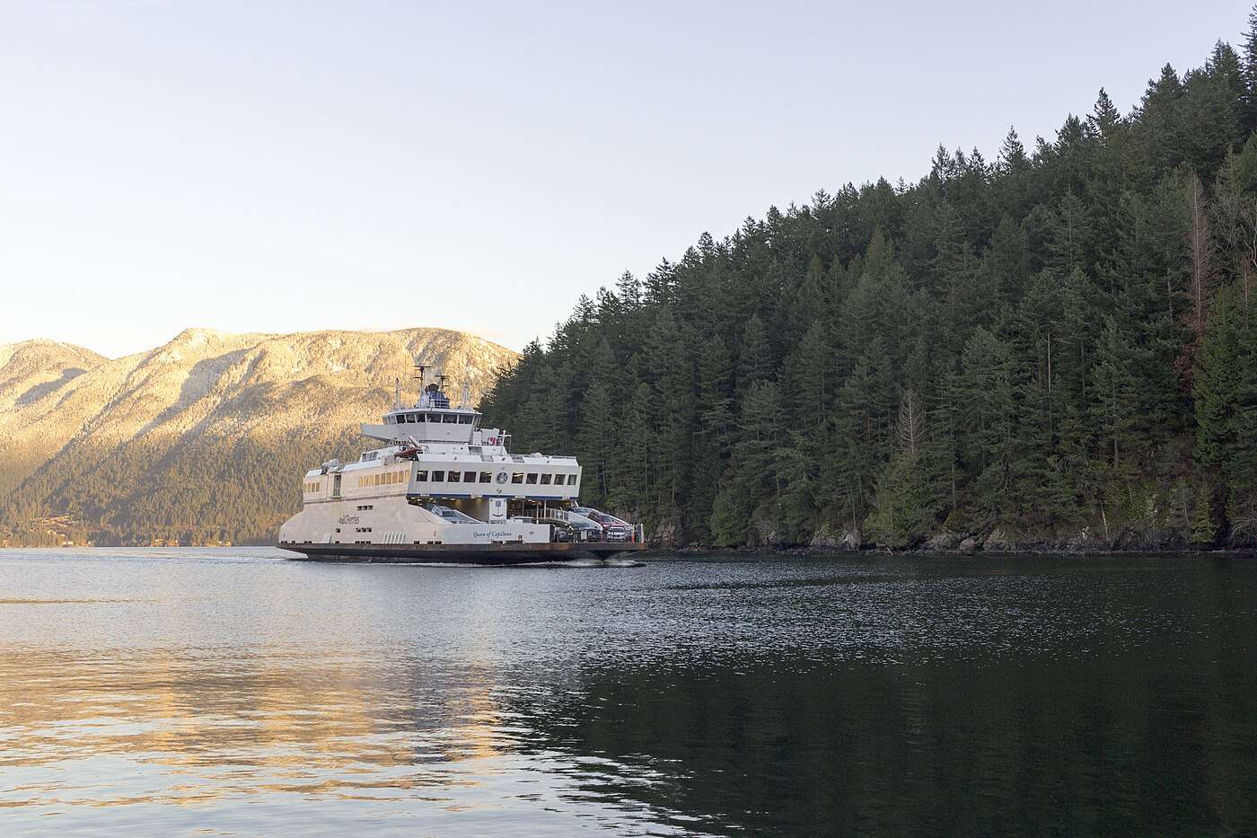 The Queen of Capilano car ferry nearing Bowen Island's forested shore in Howe Sound